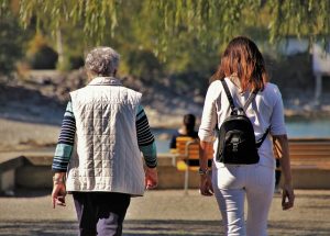 two women walking in the park during the fall