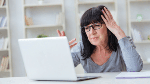 baby boomer with laptop having problem