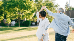 senior couple dancing outside