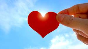 hand holding paper heart love