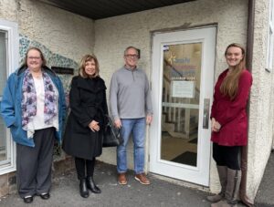 friends life care team members give donation to local charity