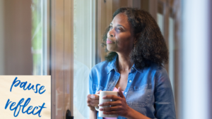 black woman reflecting and looking out window