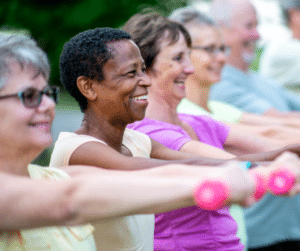 diverse group of happy older adults doing strength training