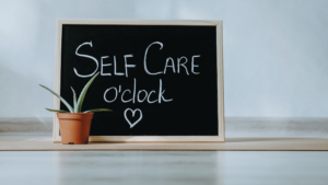 self care oclock written on chalk board